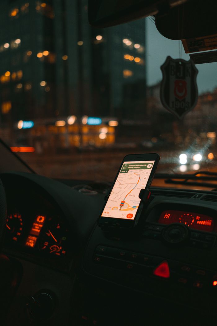 gallery-5 Car dashboard with GPS showing map on a digital screen during city driving at dusk.