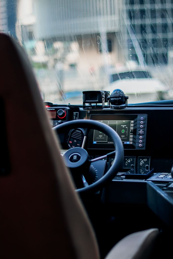 gallery-1 Close-up view of a car dashboard with digital displays in Dubai's urban setting.
