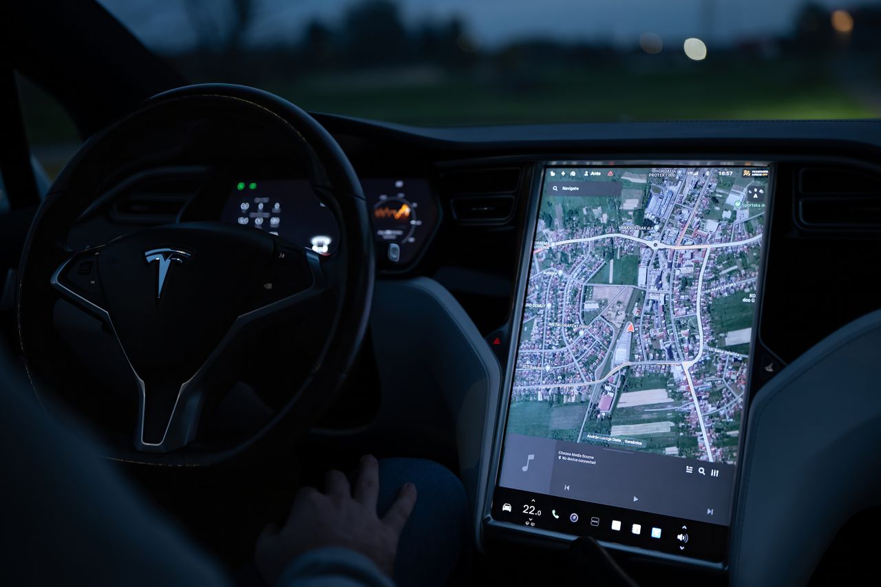 gallery-2 Explore the advanced touchscreen navigation in a modern electric vehicle's sleek interior at night.
